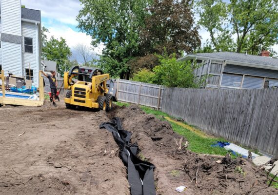 Tatra Built providing yard water drain installation services in Macomb