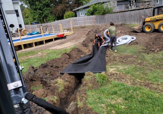 Residential yard water drain installation services with best landscaping in Macomb