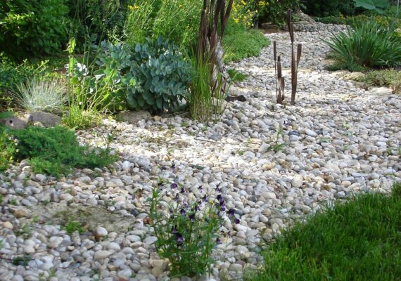 Best landscaping services in Macomb featuring dry creek bed and garden