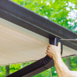 Illustration of a home gutter-to-drainage system with downspout drain installation preventing water damage