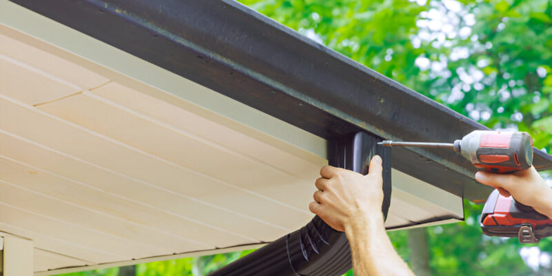 Illustration of a home gutter-to-drainage system with downspout drain installation preventing water damage