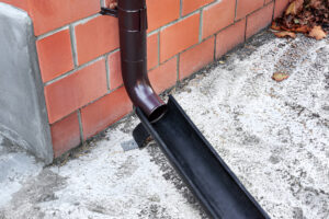 Residential downspout drain installation by Tatrabuilt to prevent water damage